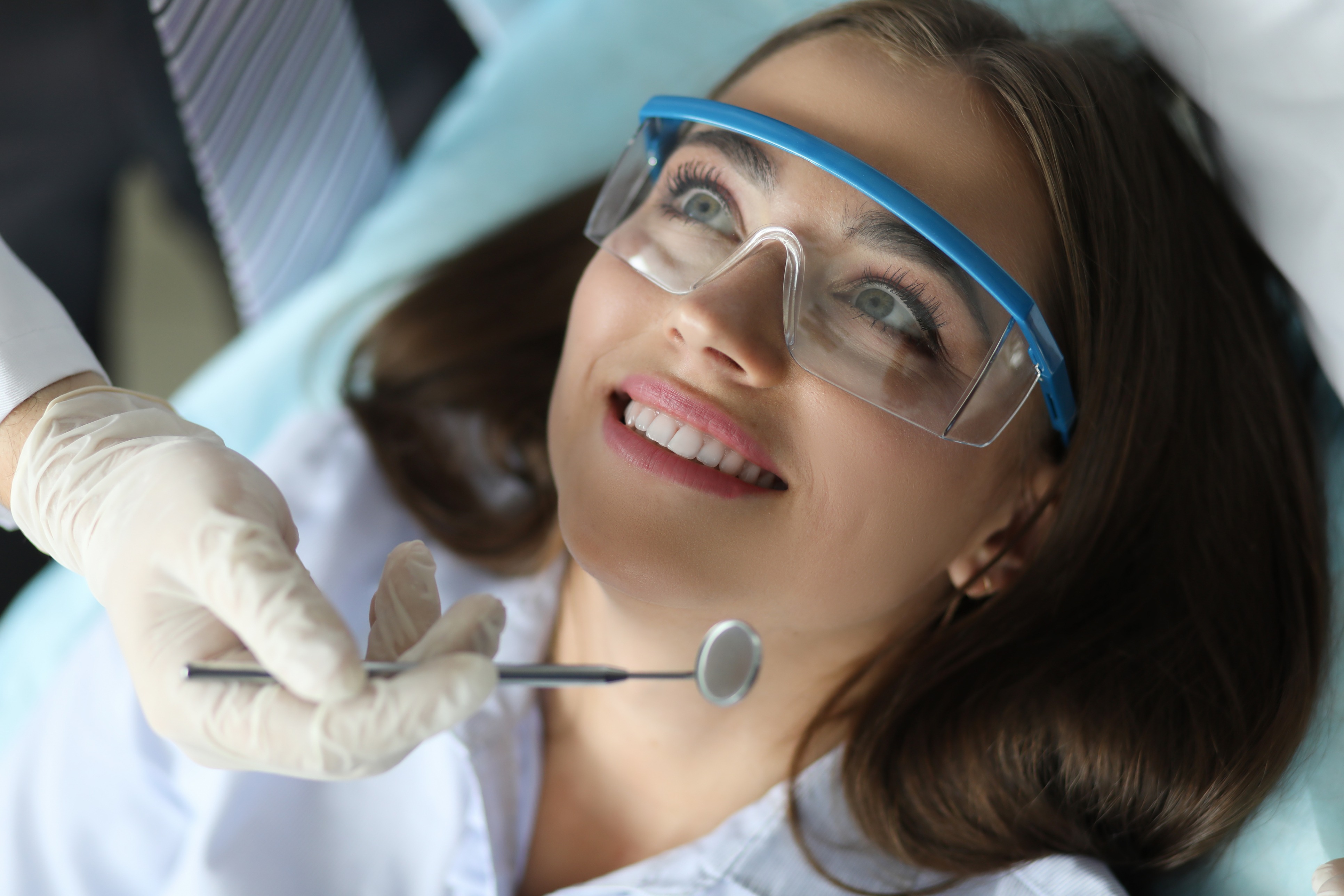 Woman sharing healthy smile after dental checkup and teeth cleaning